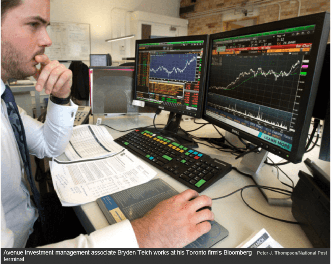 Avenue investment management associate Bryden Teich works at his Toronto firm's Bloomberg terminal